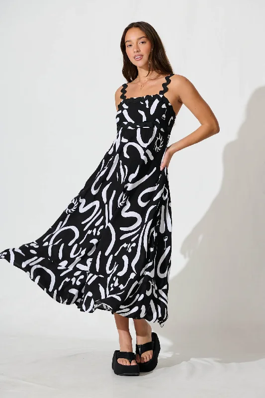 Strapless maxi dresses for a beachside vacationAquila Maxi Sundress In Black Print With Black Ric Rac Trim