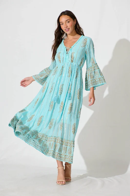 Maxi dresses with cut - out details on the sides for a modern edgeEllie Maxi Dress in Aqua Blue with Gold Print